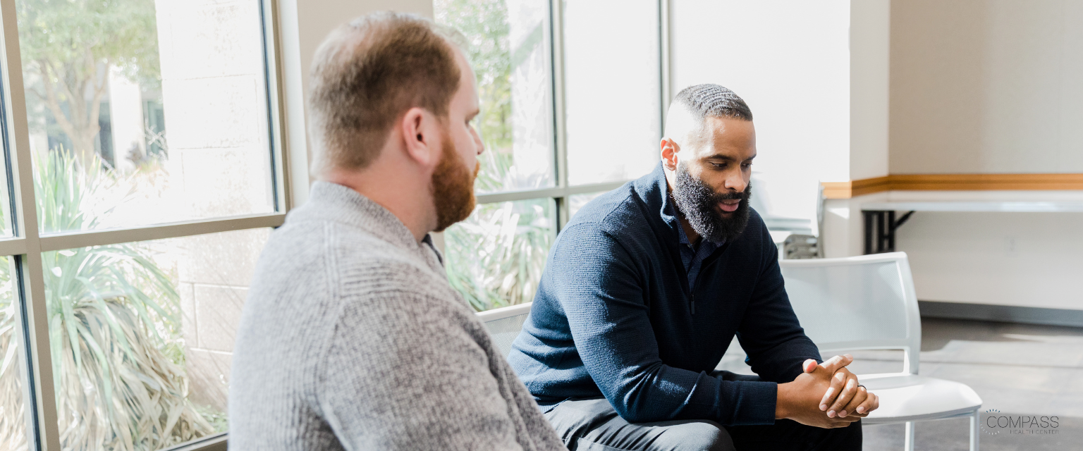  Two males talking in a group therapy session